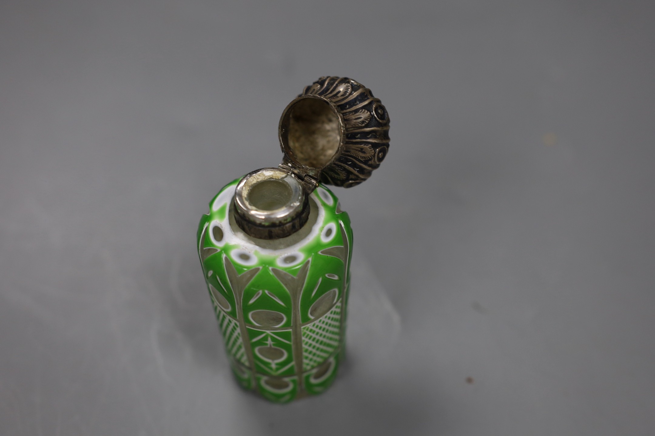 A Victorian silver mounted green and white overlaid glass scent bottle, 10cms high
